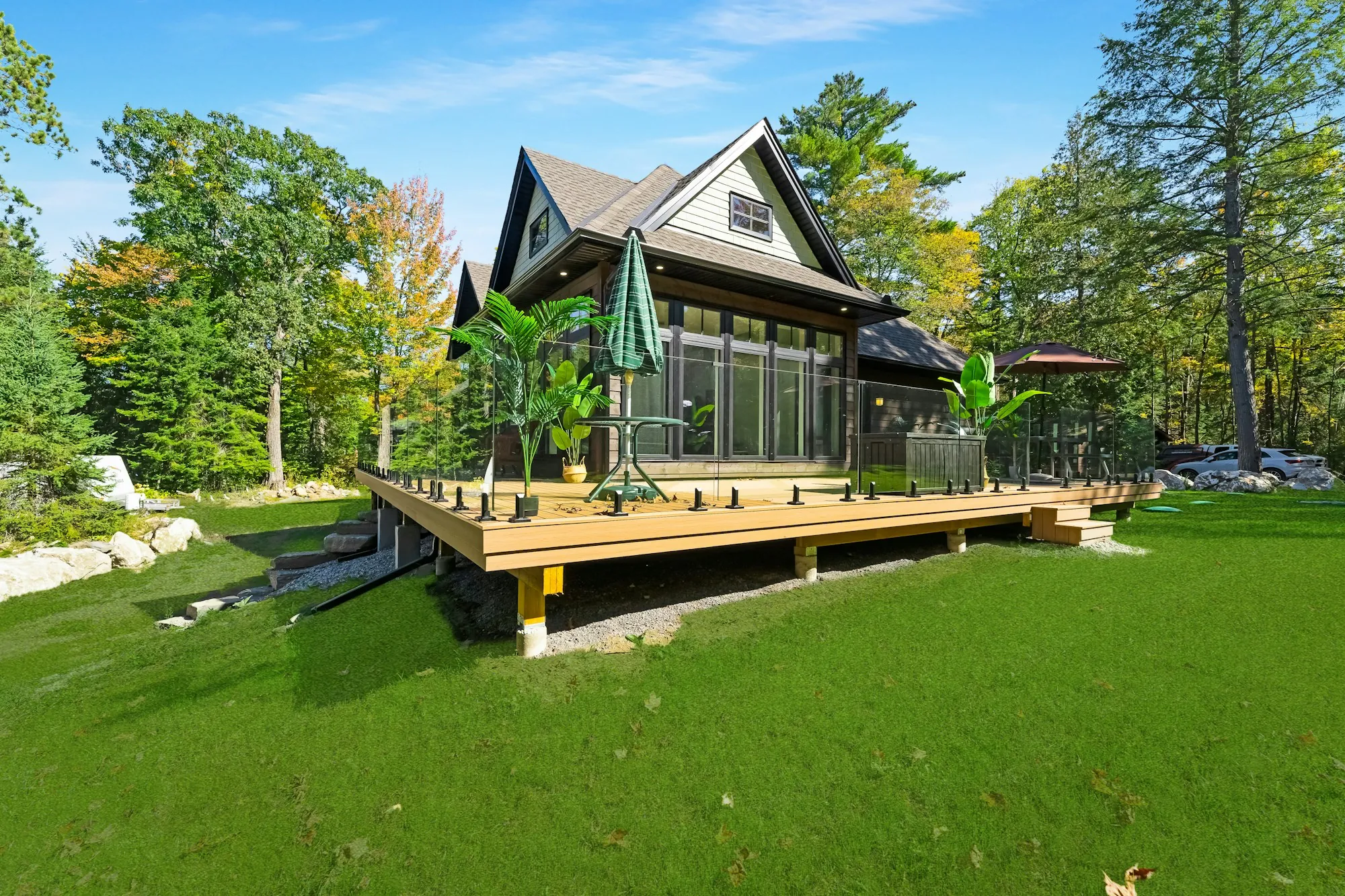 Cottage-style home with a new raised deck on a green lawn