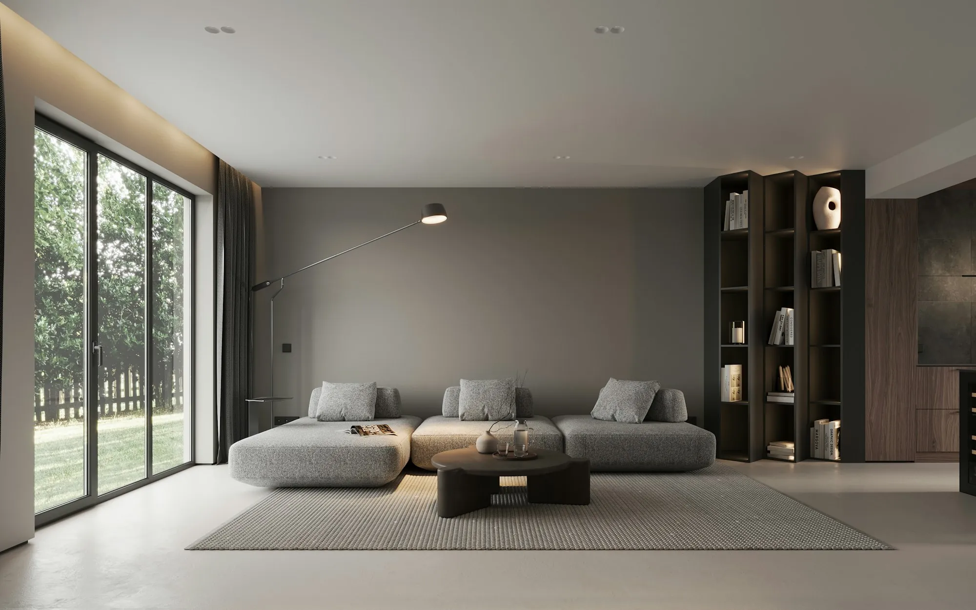 Open living area with a low gray sofa, built-in shelving and floor-to-ceiling glass doors